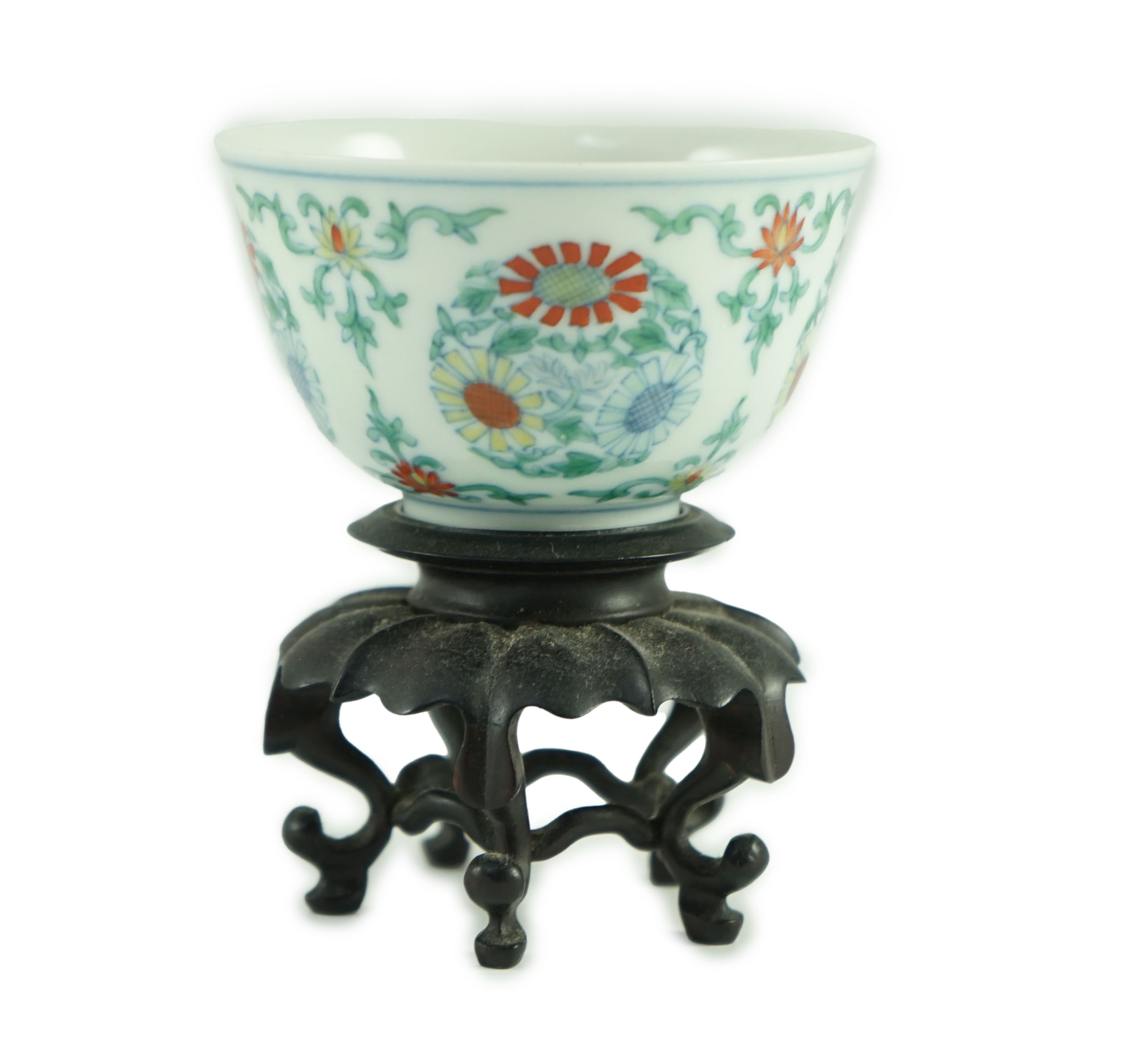 A Chinese doucai ‘chrysanthemum medallion’ cup, Yongzheng mark, probably late 19th/early 20th century, 7.2cm diameter, wood stand